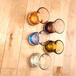 Set of 5 different colored glass salt dips with etched flower design.